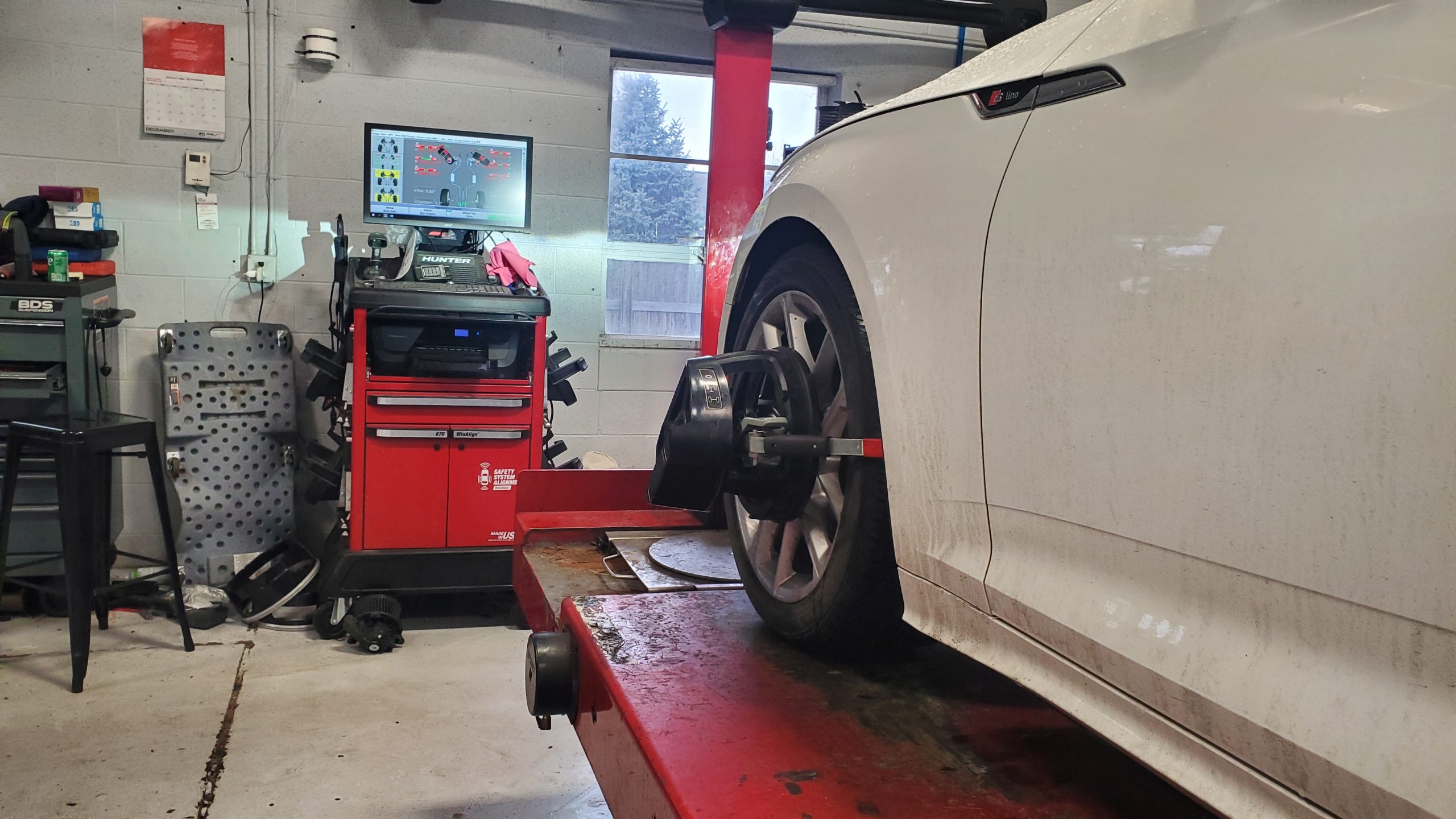 ASE-certified technician performing computerised wheel alignment at ER Autocare Columbus Ohio